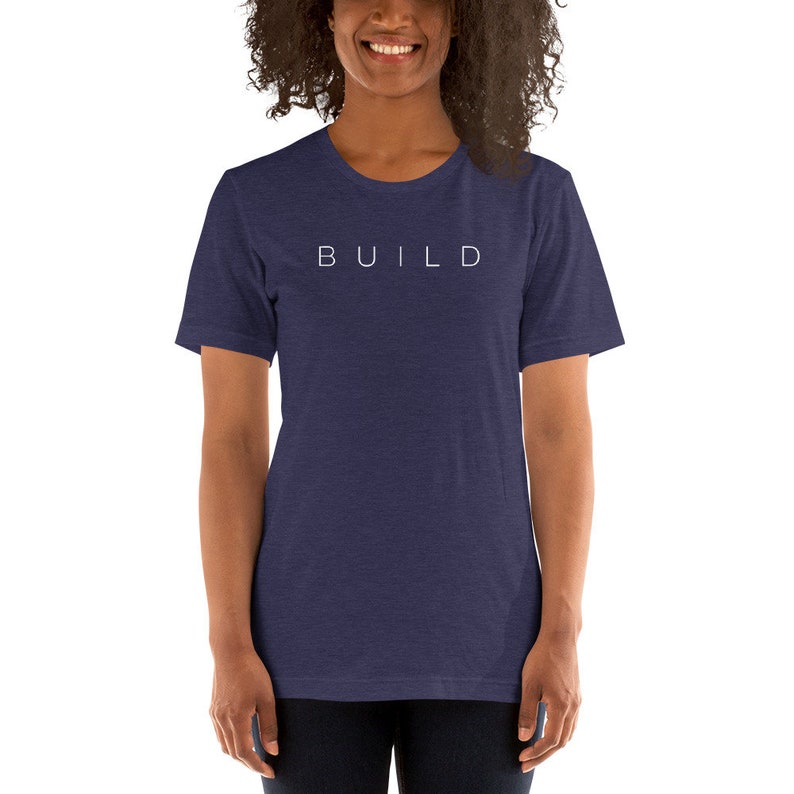 May include: A navy blue t-shirt with the word "BUILD" printed in white on the front.