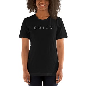 May include: A black short-sleeved t-shirt with the word "BUILD" printed in white on the front.