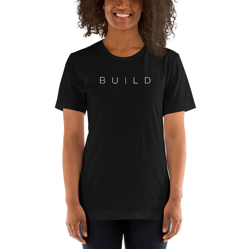May include: A black short-sleeved t-shirt with the word "BUILD" printed in white on the front.