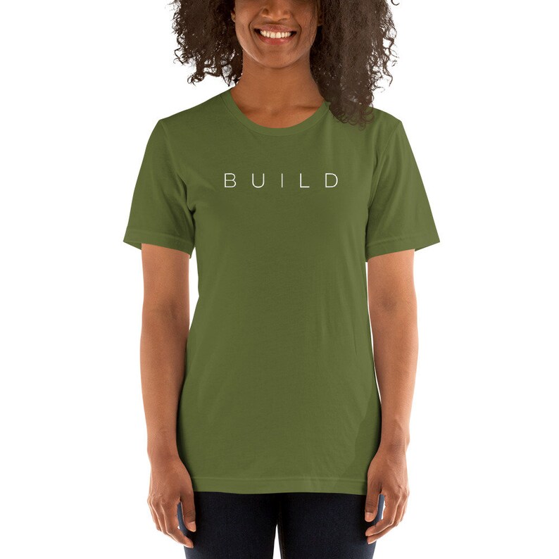 May include: A green short-sleeved t-shirt with the word "BUILD" printed in white on the front.