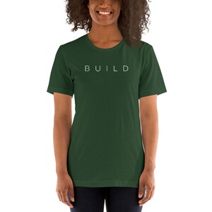 May include: A dark green t-shirt with the word "BUILD" printed in white on the front.
