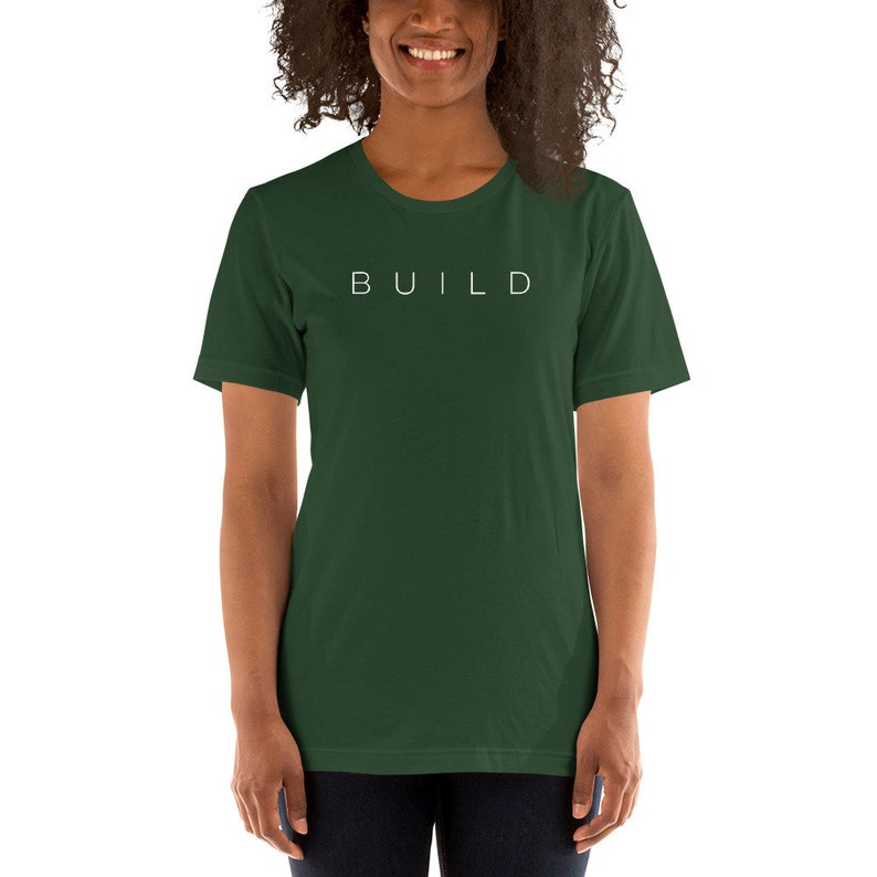 May include: A dark green t-shirt with the word "BUILD" printed in white on the front.