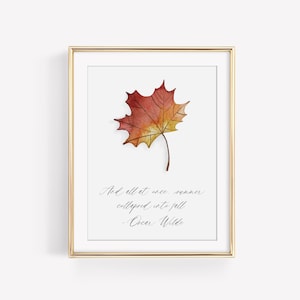 May include: A framed print with a watercolor painting of a red and yellow maple leaf. The quote "And all at once, summer collapsed into fall" by Oscar Wilde is printed below the leaf.