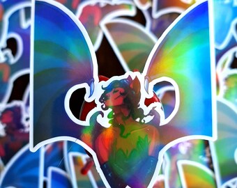 May include: A holographic sticker featuring a colourful illustration of a person with wings. The person has red hair, green eyes, and is wearing a green and red outfit. The wings are iridescent and have a rainbow effect.