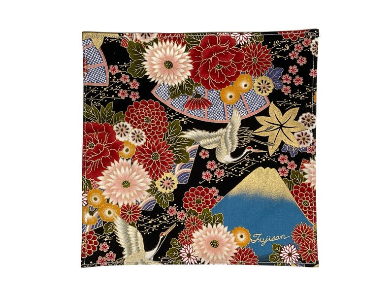 May include: Square black fabric with a Japanese-inspired floral and crane design. Features red, pink, and gold flowers, a blue mountain, and the word "Fujisan".