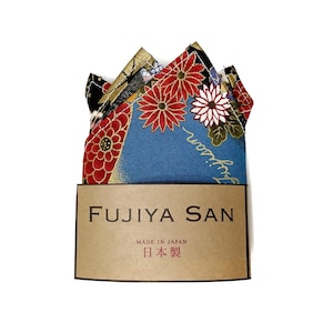 May include: A folded pocket square with a floral pattern in red, white, and gold on a blue background. The pocket square is displayed with a brown tag that reads "FUJIYA SAN" and "MADE IN JAPAN" with Japanese text.