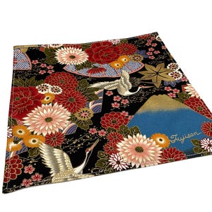 May include: Square fabric with a Japanese-inspired design. The black background is covered with red, pink, and gold floral patterns, with images of cranes and Mount Fuji. The word "Fujisan" is written on the fabric.