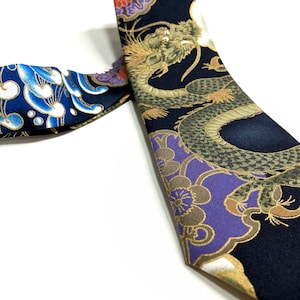 Peut inclure: Une cravate en soie noire avec un motif de dragon dor&eacute; et violet. Le dragon est entour&eacute; de fleurs et de feuilles. La cravate est r&eacute;versible, avec un motif de nuage bleu et blanc de l'autre c&ocirc;t&eacute;.