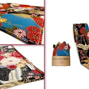 May include: A black necktie, pocket square, and fabric swatch with a Japanese floral and crane design. The tie and pocket square feature a blue mountain scene with the text "FUJIYA SAN". The fabric has red, white, and gold floral patterns.