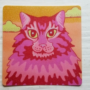 May include: A pink and red cat with yellow eyes and a fluffy mane. The cat is against a sunset background with clouds.