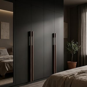 May include: A dark gray wardrobe with vertical wooden handles and a full-length mirror. The bedroom features a bed with a neutral-colored comforter, a woven rug, and a potted plant. The overall aesthetic is modern and minimalist.