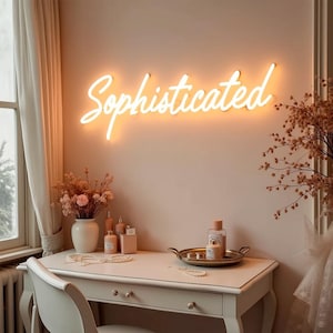 Sofisticado: luz de neón LED, brillo ámbar cálido en escritura cursiva, estilo minimalista moderno, acento elegante para interiores lujosos y de lujo