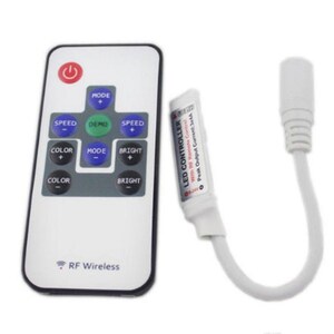 May include: A white LED controller with a white remote control. The controller has a peak output current of 34A. The remote control has buttons for mode, speed, color, and brightness. The remote control also has a power button and a demo button. The text "RF Wireless" is printed on the remote control.