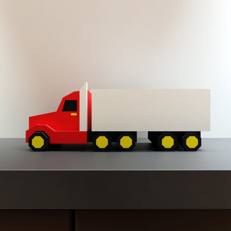 May include: A red and white toy truck with yellow wheels. The truck has a white box body and a red cab.