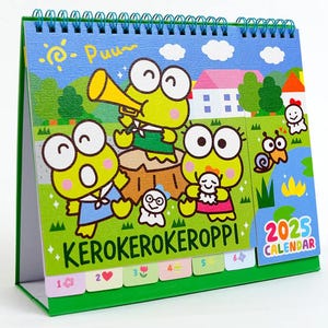 May include: A green desktop calendar featuring four cartoon frogs with the text "KEROKEROKEROPPI!" and "2025 CALENDAR".