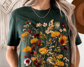 May include: A dark green t-shirt with a floral print featuring a variety of dried flowers in shades of yellow, orange, red, and white.