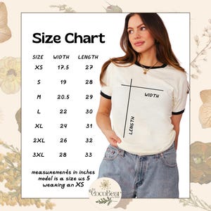 May include: A size chart with measurements in inches for t-shirts, with sizes ranging from XS to 3XL. The chart shows width and length measurements. A model wearing an XS t-shirt is also shown.