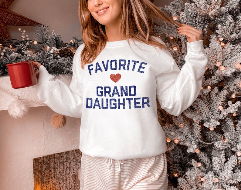 white long-sleeves sweatshirt print the phrase "Favorite Granddaughter" and a small heart image is the best Christmas gifts for granddaughter