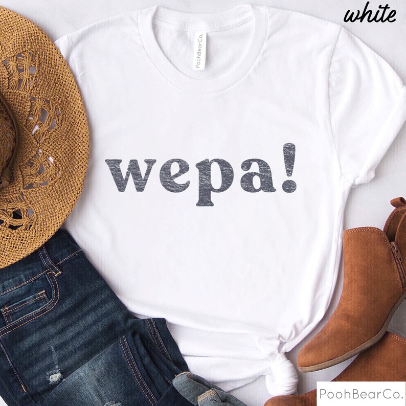 May include: White t-shirt with the text "wepa!" printed in black on the front.