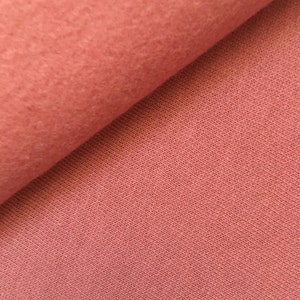 May include: Close-up of a soft, pink fabric with a textured surface. The fabric is folded in half, showing the inside and outside of the material.