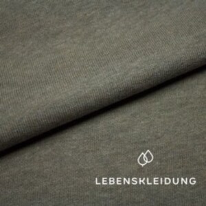 May include: Close-up of a soft, textured, green fabric. The fabric has a subtle ribbed texture and a slightly faded appearance.