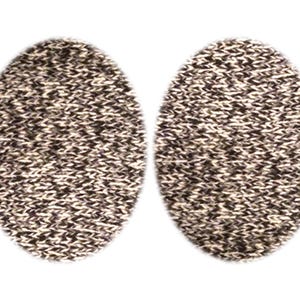 May include: Two oval-shaped knitted patches in a black and white pattern.