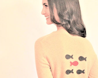 Photo of Model in Sweater with Unique Fish Patch in School of Fish Patches on Back