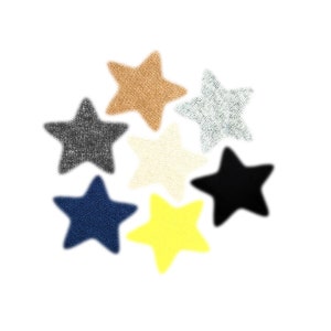 May include: Seven star-shaped fabric patches in different colors: brown, gray, white, black, blue, and yellow. The patches are arranged in a circle.