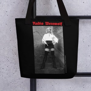 May include: Black tote bag with a white and black photo of a woman holding a whip. The text "Radio Werewolf" is printed in red on the bag.
