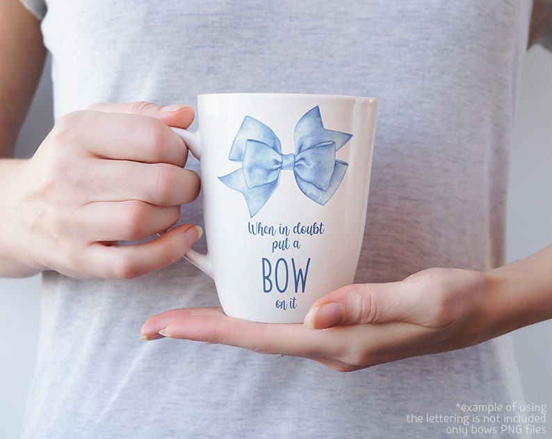 May include: White ceramic mug with a blue watercolor bow and the text "When in doubt put a BOW on it".