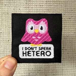 Peut inclure: Patch brodé noir avec un hibou rose et le texte "Je ne parle pas hétéro".