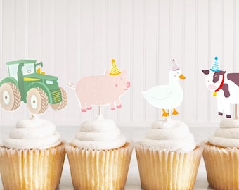 May include: Six cupcakes topped with farm animal-themed decorations. The toppers include a green tractor, a pink pig, a white duck, a cow, a chicken with chicks, and a sheep, all wearing party hats. The cupcakes have white frosting.
