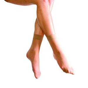 May include: A pair of nude sheer ankle socks with a beige band at the top of the sock.
