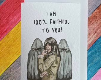 May include: A greeting card with a watercolor illustration of a woman with long dark hair wearing a brown jacket and standing between two figures wearing grey hooded cloaks. The text on the card reads "I am 100% Faithful to You!"