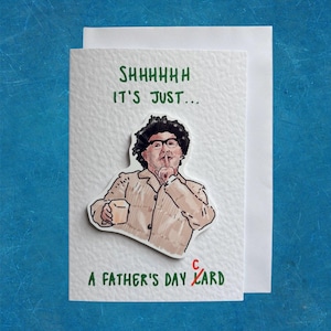 May include: A white greeting card with the text "SHHHHHH IT'S JUST..." in green. Below is an illustration of a person with glasses and a finger to their lips. The text "A FATHER'S DAY CARD" is printed below the illustration.