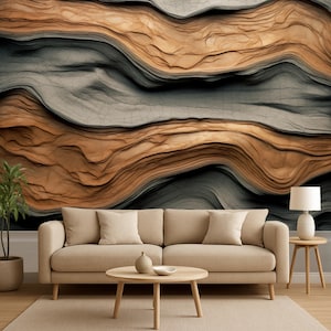May include: A living room scene featuring a beige sofa with throw pillows, a round wooden coffee table, and a side table with a lamp. The wall behind the furniture has a textured, abstract design in shades of brown and gray.