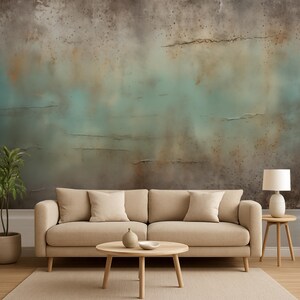 May include: A living room scene featuring a beige sofa with matching throw pillows, a round wooden coffee table, and a small side table. The backdrop is a textured wall with shades of brown, teal, and beige. A potted plant and a lamp complete the decor.