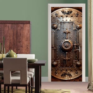 May include: A close-up of a metal door with a large, circular lock in the center. The door is made of thick metal and has a weathered, industrial look. The door is surrounded by a white frame.