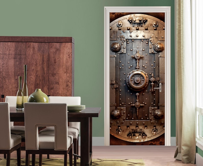 May include: A close-up of a metal door with a large, circular lock in the center. The door is made of thick metal and has a weathered, industrial look. The door is surrounded by a white frame.