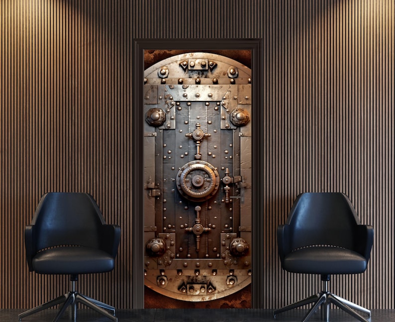 May include: A large, metal vault door with intricate details and a circular lock in the center. The door is a dark gray color with hints of gold and rust. The door is set against a backdrop of brown wood paneling.