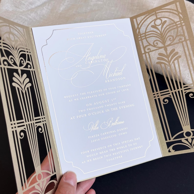 Luxurious wedding invitation made of gold foil, in a lace-cut cover in the Gatsby style