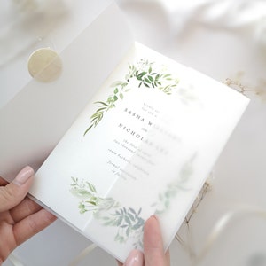 Puede incluir: Una invitaci&oacute;n de boda blanca con un dise&ntilde;o floral verde. La invitaci&oacute;n dice "Por favor, responde a la invitaci&oacute;n para la boda de Sasha W y Nicholas el primero de noviembre de dos mil Santa Barbara, California invitaci&oacute;n formal a seguir."