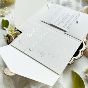Luxurious wedding invitation made of gold foil in a pocket