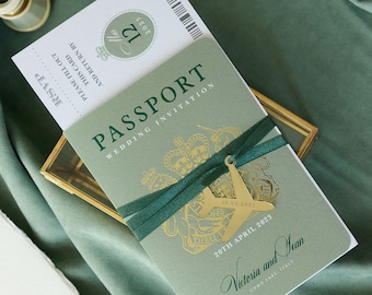 Invitación de boda de lujo en color verde salvia con diseño de pasaporte, lámina dorada y grabado de avión, destino y boda en el extranjero con tarjeta de embarque.