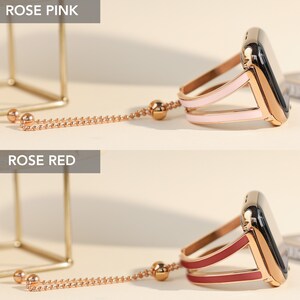 May include: Two gold-tone Apple Watch bands with a chain and a charm. The band on the top is rose pink and the band on the bottom is rose red.
