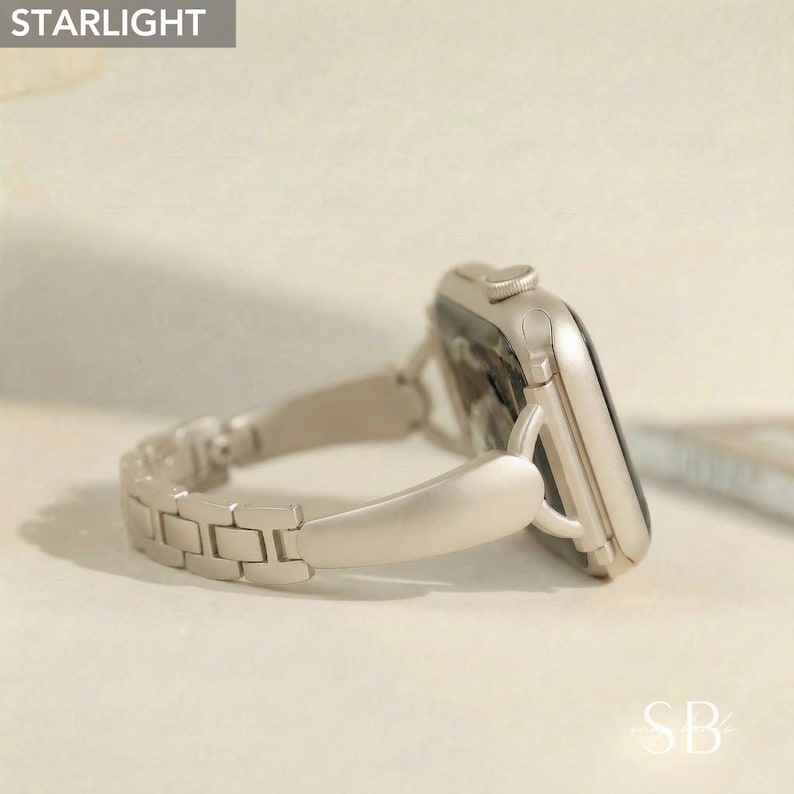 May include: A gold-colored smartwatch with a matching metal band. The watch face is black, and the band is made of rectangular links. The word "STARLIGHT" is in the top left corner of the image.