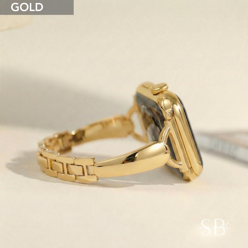 May include: A gold-colored smartwatch with a matching gold band. The band features a series of rectangular links. The watch face is black. The word "GOLD" is in a gray box in the upper left corner.