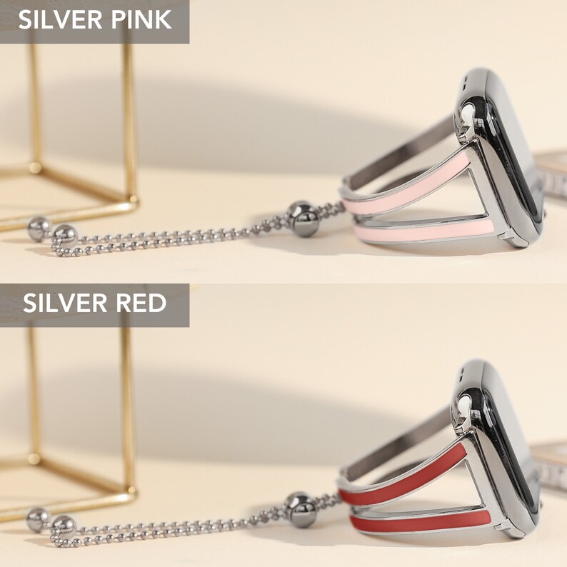 May include: Two silver Apple Watch bands with a chain and a charm. The band on the top is pink and the band on the bottom is red.