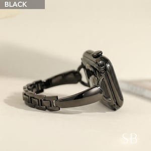 May include: A black smartwatch with a matching black metal link band. The watch face is glossy and the band has a series of rectangular links. The word "BLACK" is in a gray box in the upper left corner.