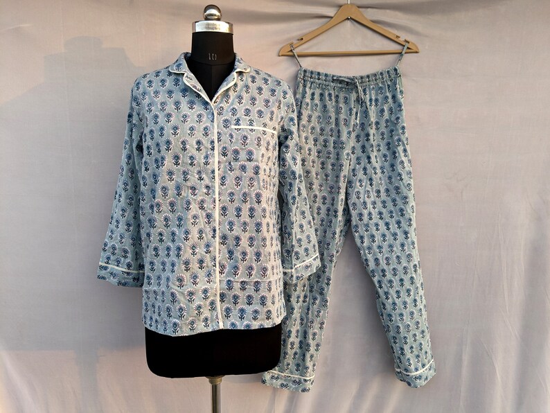 May include: A blue and white floral print pajama set with a long-sleeved shirt and pants.